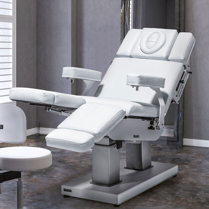 Luxurious Gharieni spa treatment table in modern, elegant setting.