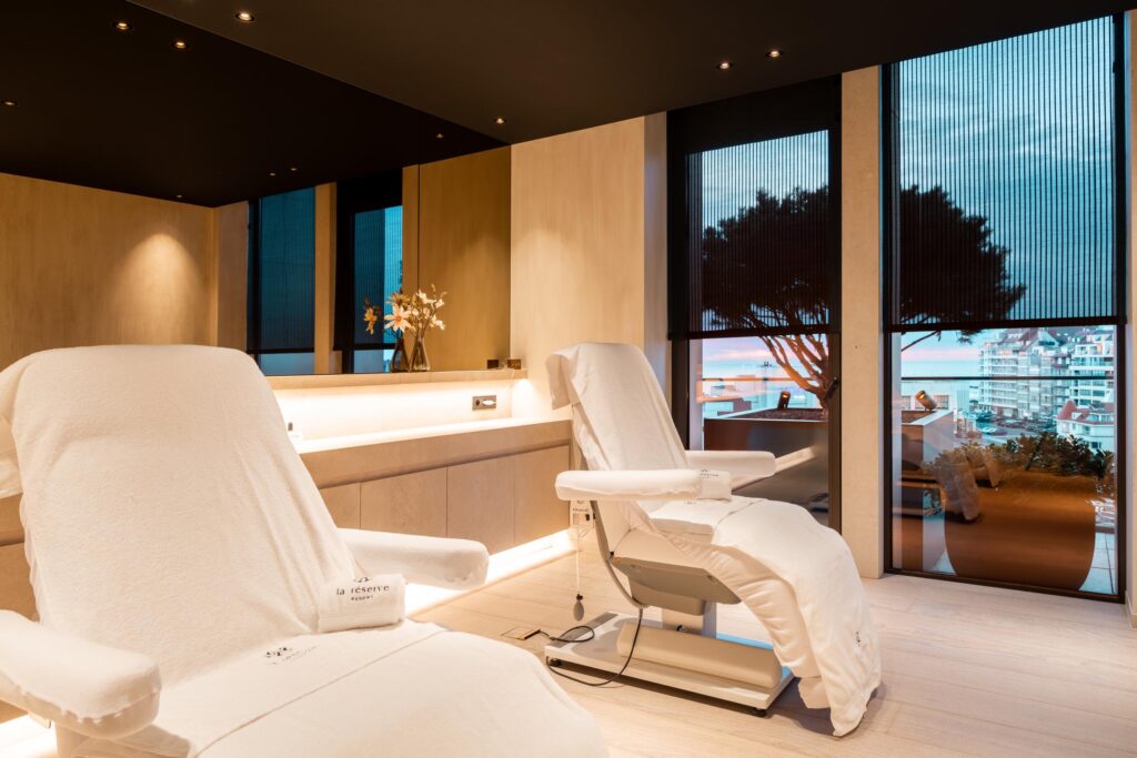 Luxurious spa treatment room with premium Gharieni chairs and panoramic view.