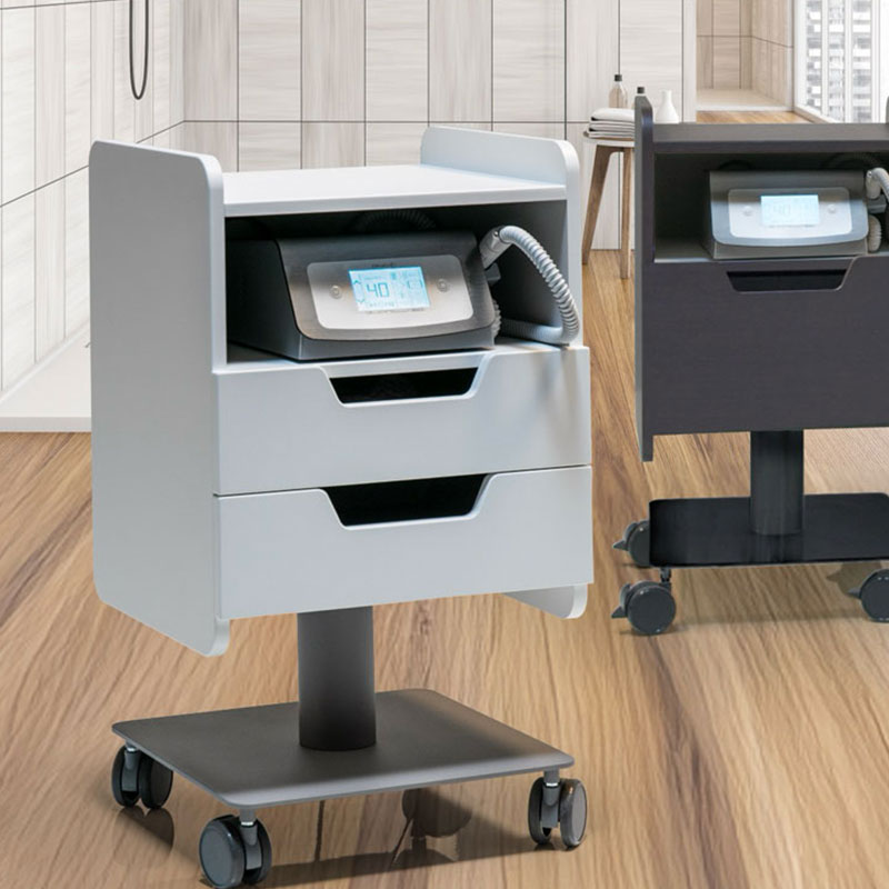 Modern spa equipment on wheeled stand in elegant treatment room.