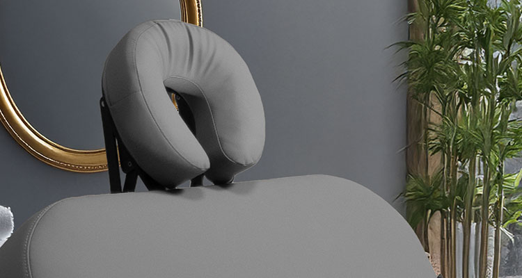 Gharieni luxury treatment table with plush headrest, elegant spa setting.