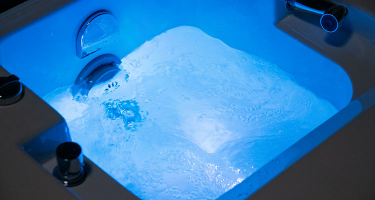 Luxurious spa bath with soothing blue LED lighting and advanced hydrotherapy features.