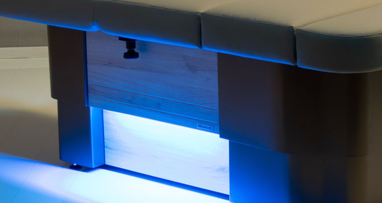 Luxurious Gharieni spa treatment table with ambient LED lighting.