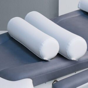 Luxurious Gharieni spa treatment table with plush white cushions.