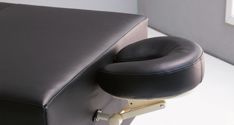 Luxurious Gharieni spa treatment table with ergonomic headrest design.