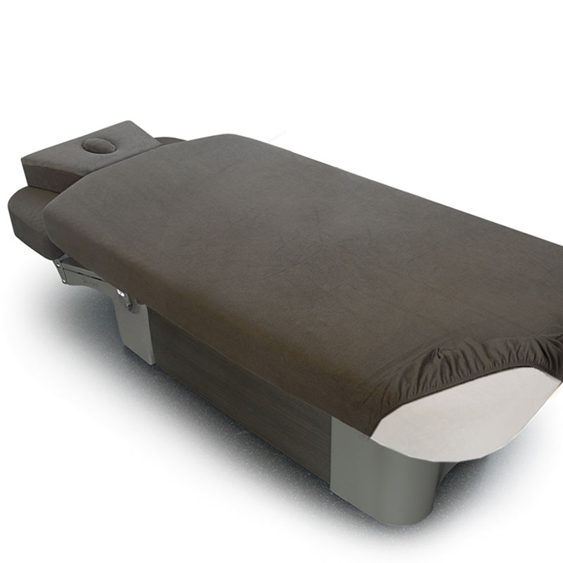 Luxurious Gharieni spa treatment table with ergonomic design and premium materials.