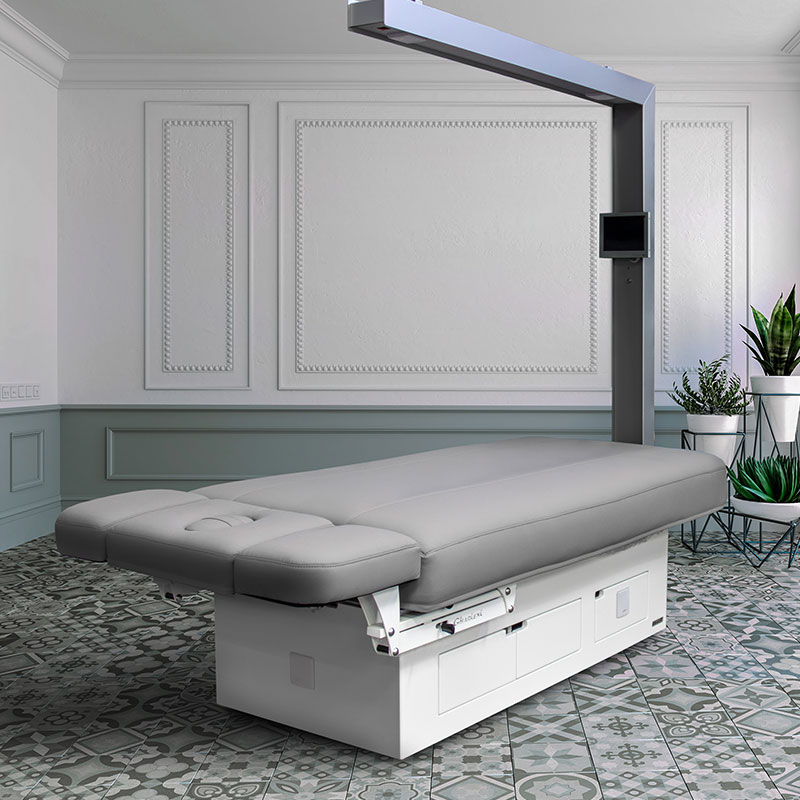 Gharieni premium spa treatment table in elegant, modern interior setting.