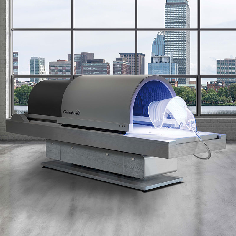 Gharieni premium spa treatment table with futuristic design and urban skyline backdrop.