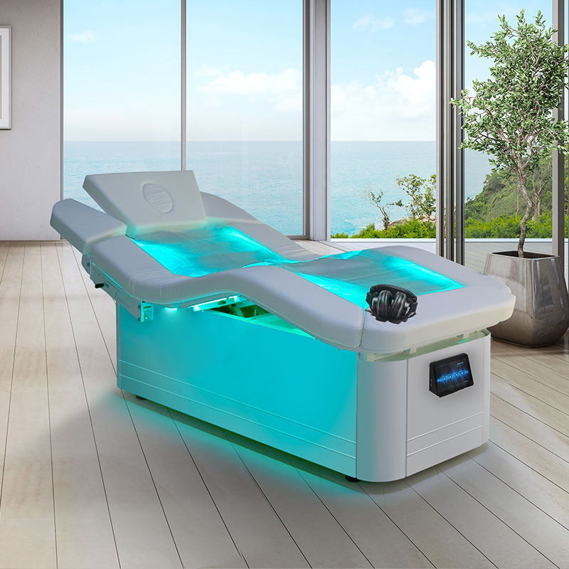 Luxurious spa treatment table with ocean view, featuring LED lighting.