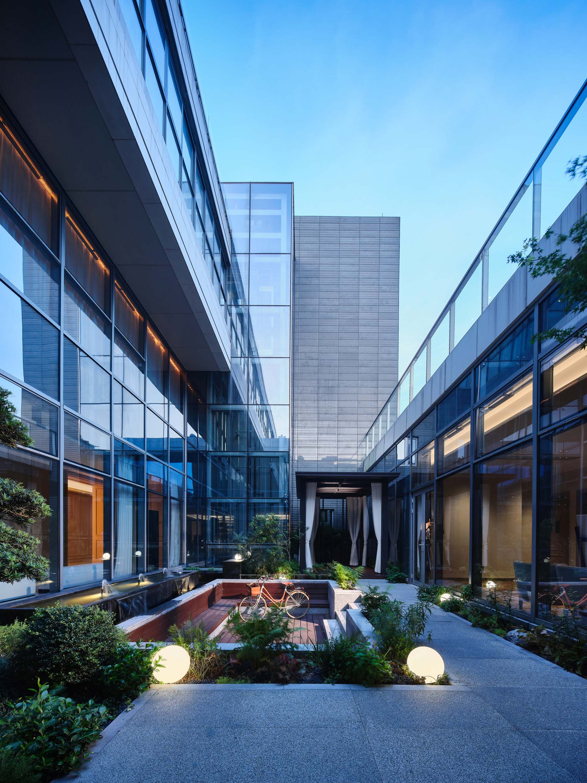 Luxurious outdoor spa courtyard with modern design and ambient lighting.